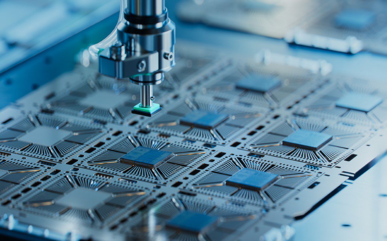 GettyImages-1468266144 Robotic arm assembling electronic circuit boards.